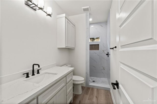 1114 Knotty Pine Ln, Harlingen, TX 78552 - full bath with a marble finish shower, vanity, wood finished floors, and recessed lighting