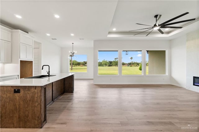1114 Knotty Pine Ln, Harlingen, TX 78552 - kitchen featuring open floor plan, white cabinetry, light wood finished floors, an island with sink, and recessed lighting