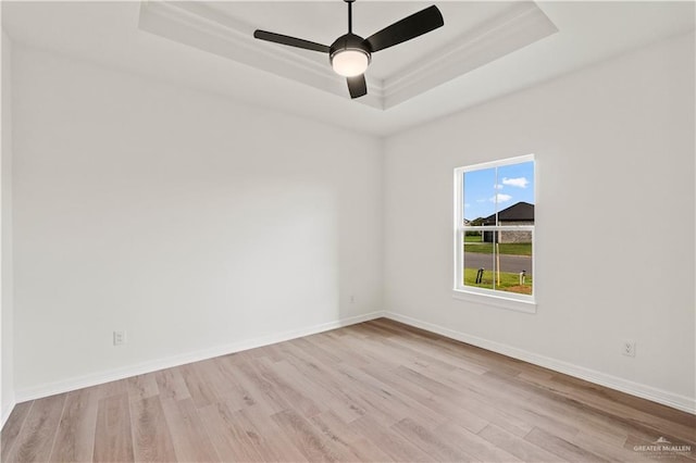 1114 Knotty Pine Ln, Harlingen, TX 78552 - unfurnished room with a tray ceiling, wood finished floors, and ceiling fan