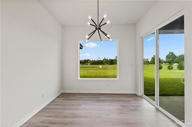 1114 Knotty Pine Ln, Harlingen, TX 78552 - unfurnished dining area with a chandelier and light wood-type flooring