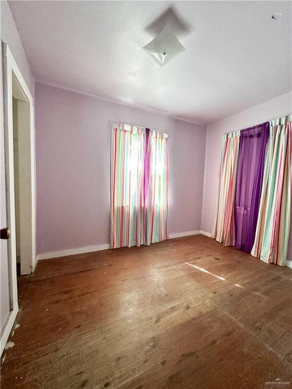 spare room featuring wood-type flooring