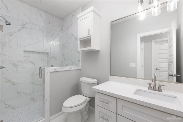 bathroom featuring vanity, toilet, and a shower with shower door