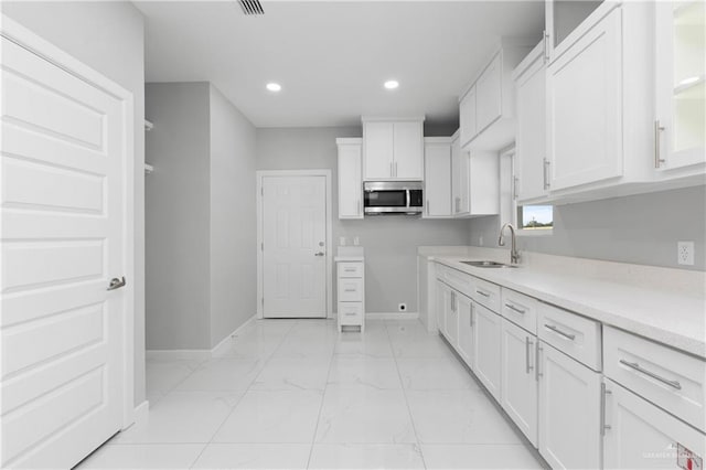 kitchen with white cabinetry and sink