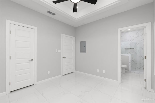 unfurnished bedroom featuring electric panel, ensuite bathroom, and ceiling fan