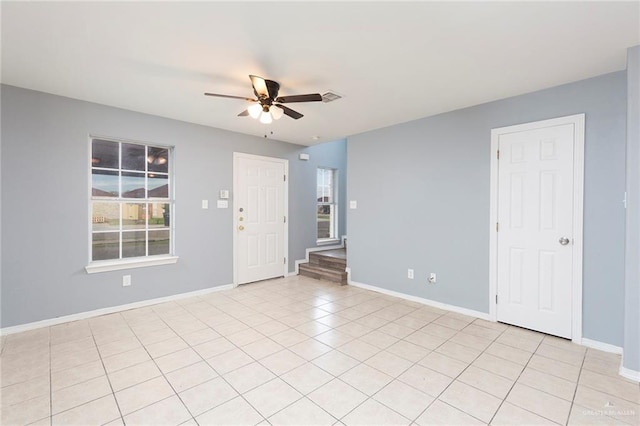 unfurnished room with light tile patterned floors and ceiling fan