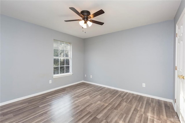 spare room with hardwood / wood-style flooring and ceiling fan