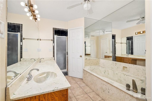 bathroom with tile patterned floors, vanity, and independent shower and bath