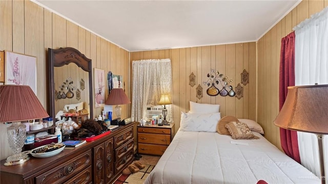 bedroom with ornamental molding and wood walls