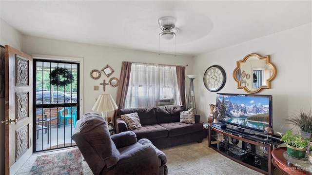 carpeted living room with ceiling fan