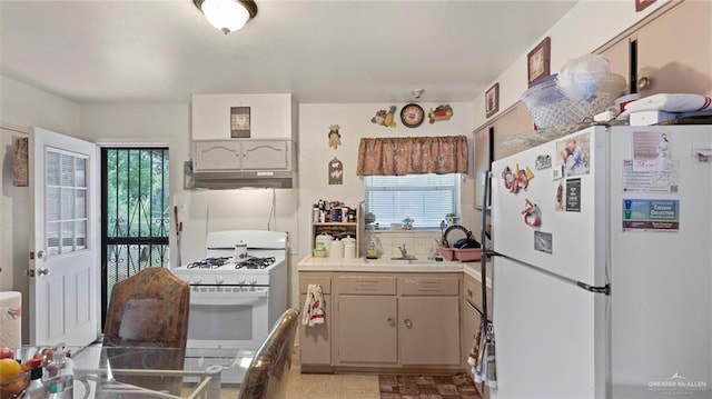 kitchen with sink, white appliances, and exhaust hood