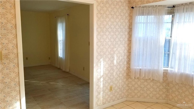 unfurnished room with light tile patterned floors