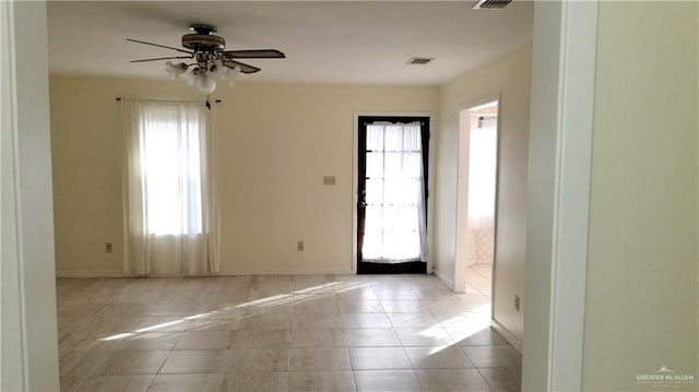 interior space with ceiling fan and light tile patterned floors