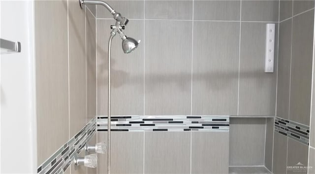 interior details featuring a tile shower