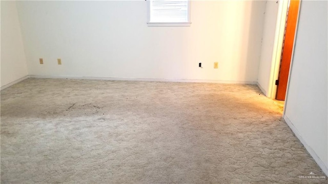 unfurnished room featuring light carpet