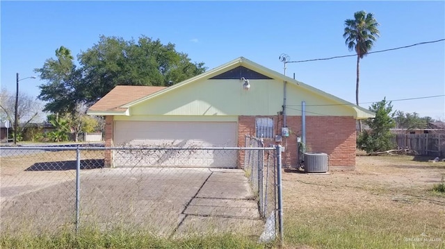 view of property exterior featuring cooling unit, a garage, and an outbuilding