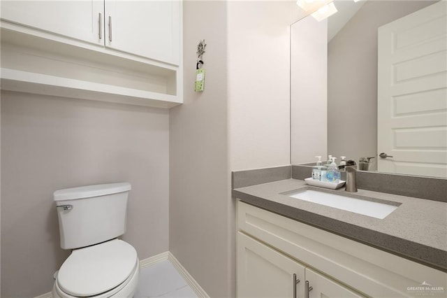 half bath featuring vanity, toilet, and baseboards