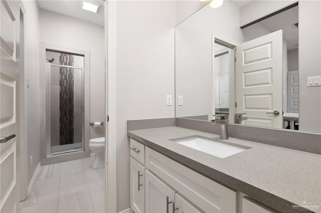 bathroom featuring toilet, marble finish floor, a shower stall, and vanity