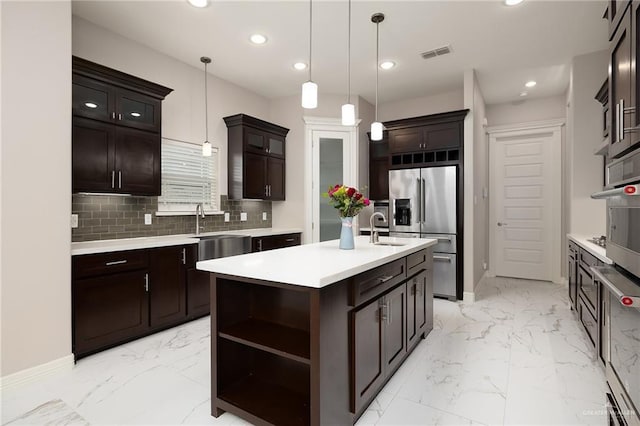 kitchen with appliances with stainless steel finishes, recessed lighting, marble finish floor, and light countertops