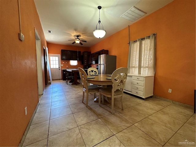 dining area featuring light tile patterned floors and ceiling fan