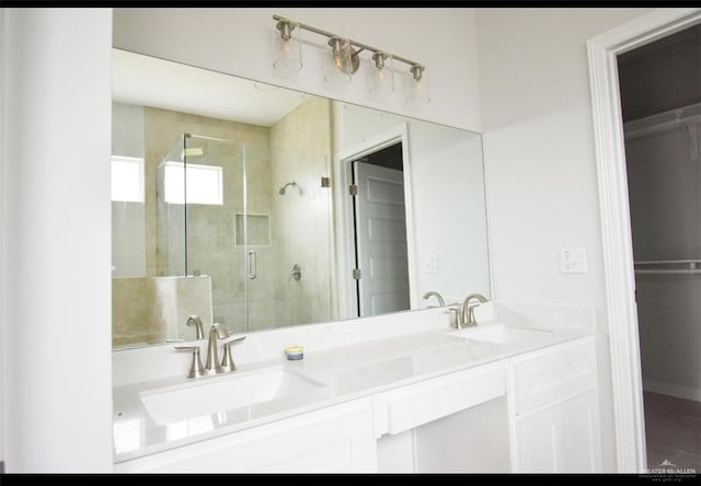 bathroom with walk in shower and vanity