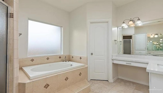 bathroom featuring an enclosed shower, tile patterned flooring, and a garden tub