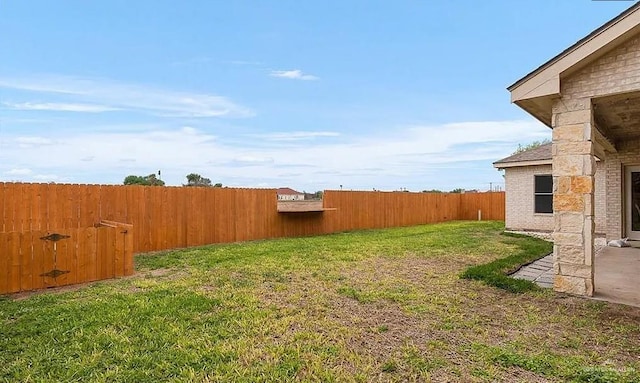 view of yard with a fenced backyard