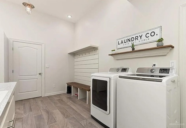 clothes washing area with washer and dryer, recessed lighting, laundry area, and baseboards