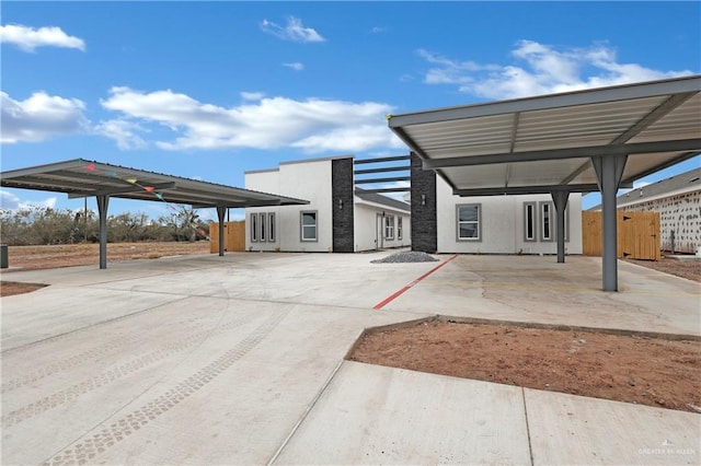 view of patio with a carport and fence