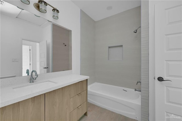 full bathroom with shower / bathing tub combination, vanity, and wood finished floors