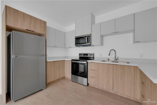 kitchen featuring light countertops, appliances with stainless steel finishes, modern cabinets, and white cabinets