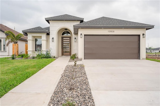 view of front facade with a front yard and a garage