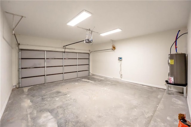 garage featuring electric water heater and a garage door opener