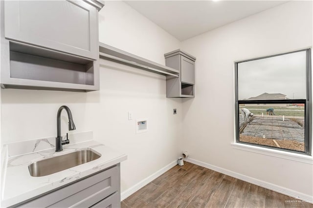 washroom featuring sink, cabinets, dark wood-type flooring, hookup for an electric dryer, and hookup for a washing machine