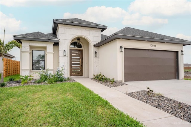 view of front facade featuring a front yard and a garage