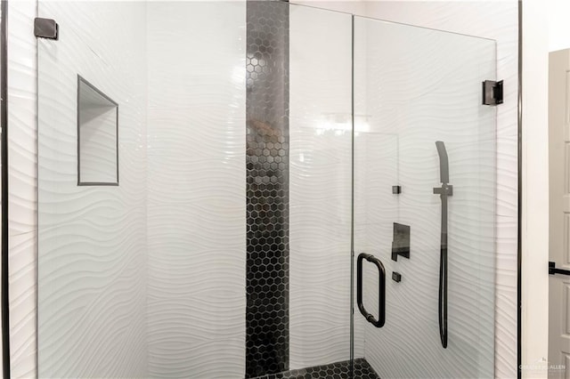 details with a shower with door