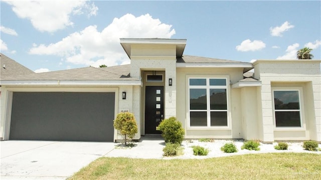 prairie-style house featuring a front yard and a garage