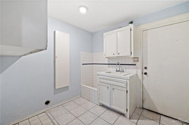 laundry room with light tile patterned floors and sink