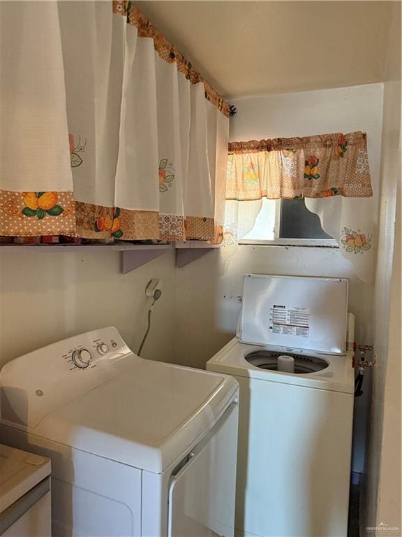 washroom with independent washer and dryer and laundry area