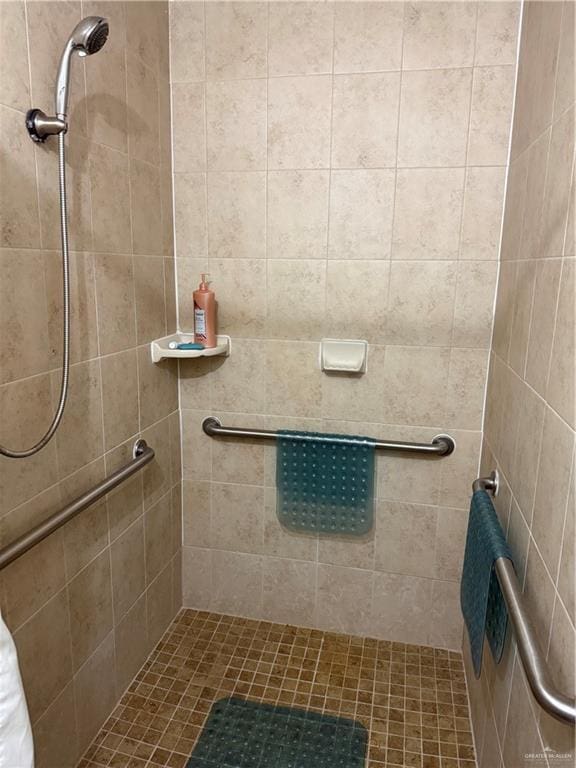 full bath featuring a tile shower