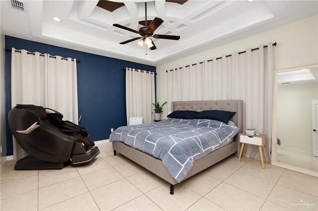 tiled bedroom featuring ceiling fan, a tray ceiling, and coffered ceiling