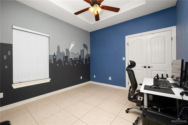 tiled office space featuring ceiling fan