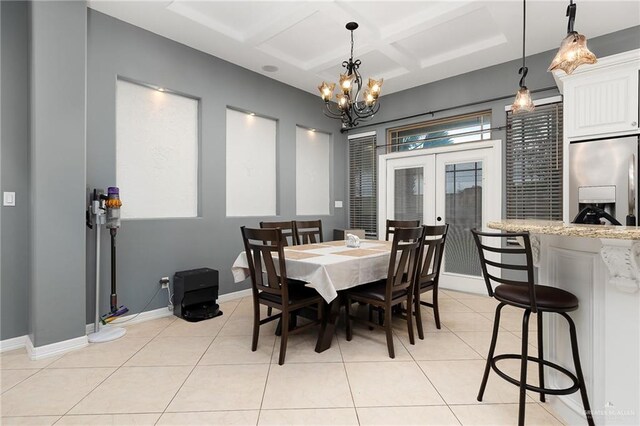 dining room with french doors, light tile patterned floors, a chandelier, and coffered ceiling