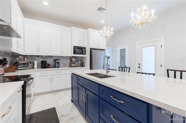 713 Santa Cecilia St, Donna, TX 78537 - kitchen with blue cabinets, wall chimney exhaust hood, a sink, an inviting chandelier, and black appliances