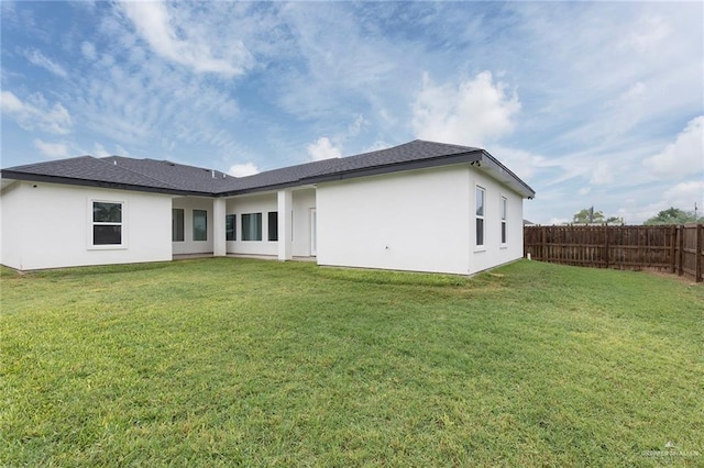 713 Santa Cecilia St, Donna, TX 78537 - back of house featuring a lawn, fence, and stucco siding