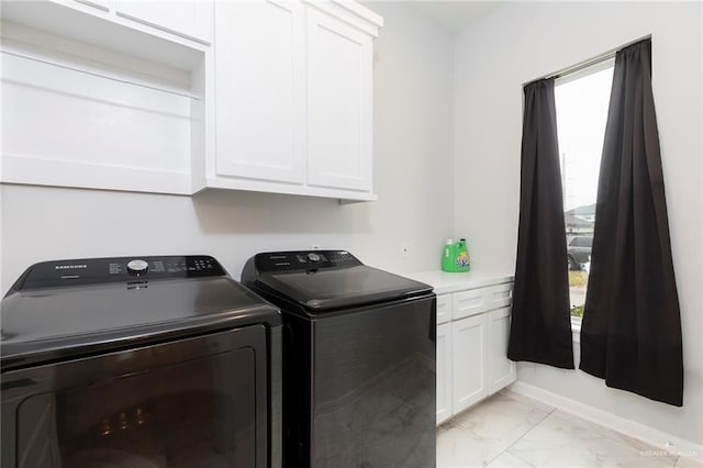 713 Santa Cecilia St, Donna, TX 78537 - clothes washing area with marble finish floor, washer and clothes dryer, and cabinet space
