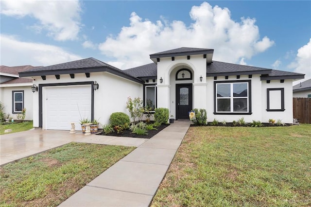713 Santa Cecilia St, Donna, TX 78537 - view of front of house featuring a front lawn, driveway, fence, a garage, and roof with shingles