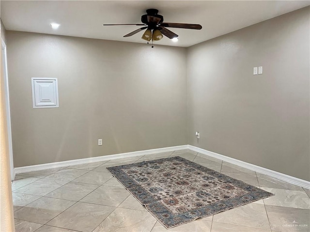 unfurnished room with ceiling fan and baseboards