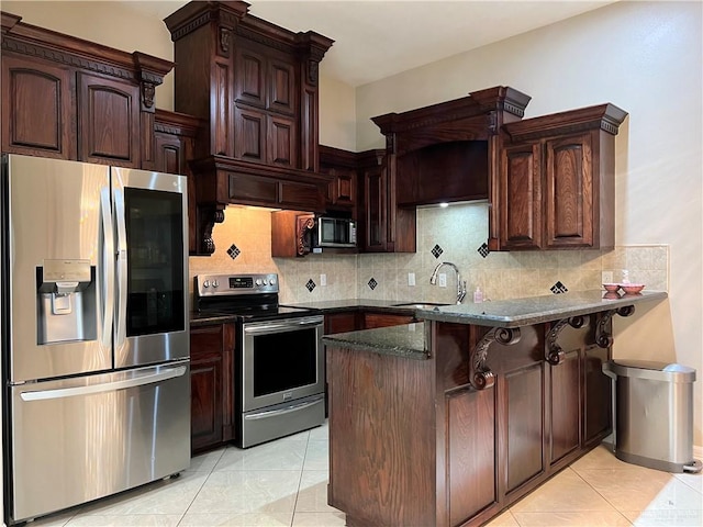 kitchen featuring appliances with stainless steel finishes, a sink, a peninsula, and tasteful backsplash