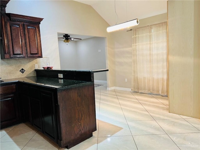 kitchen featuring light tile patterned floors, ceiling fan, lofted ceiling, dark brown cabinets, and backsplash