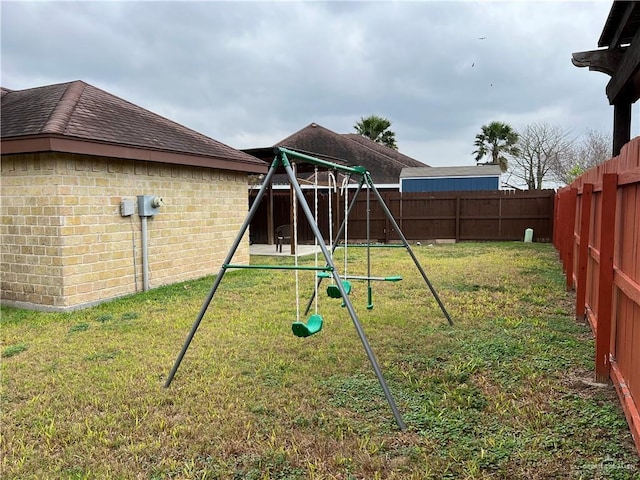 view of play area with a fenced backyard and a lawn